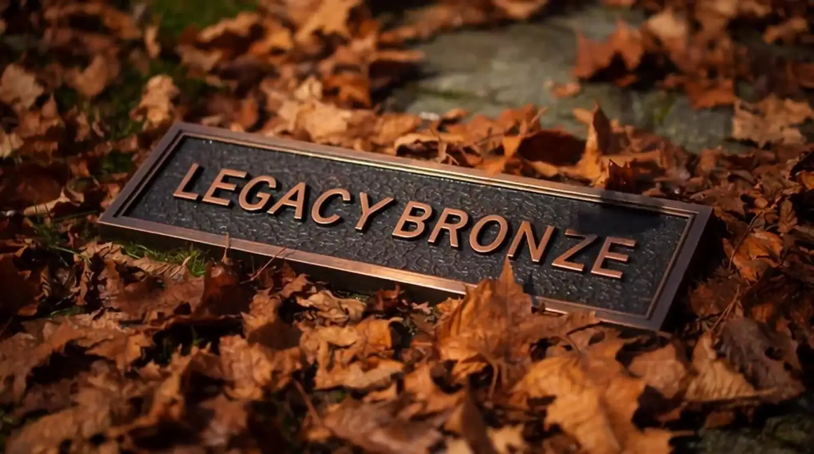Legacy Bronze memorial plaque cast in bronze, resting among autumn leaves